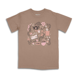 T-shirt with "Mythical" text and graphic design featuring a teapot, flowers, a book, and other items.
