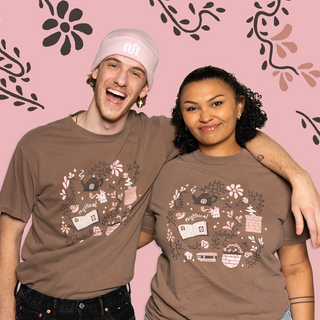 Brown t-shirt with Mythical Morning design, including teapot, flowers, and 'mythical' text.