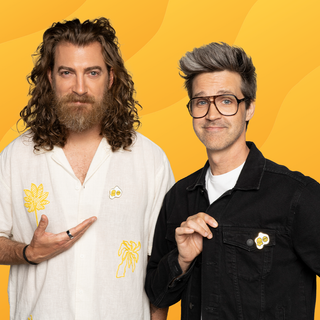 Sunny Side Up Pin of the Month: Two men with egg pins on their shirts.