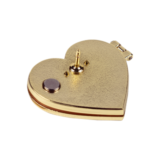 Angled view of gold heart pin with "Stinky. Horny. But most importantly, locked away" message.
