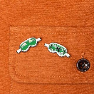 Pins of the Month: Rhett and Link wearing blindfold mini pins on an orange jacket.